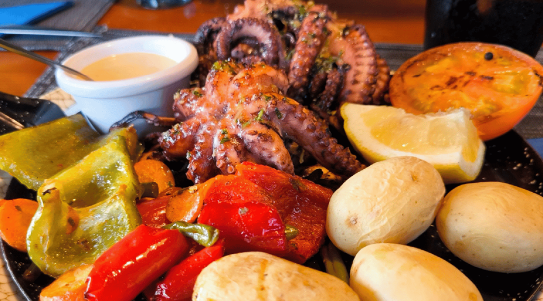 Traditional Canarian dish - grilled octopus with wrinkled potatoes